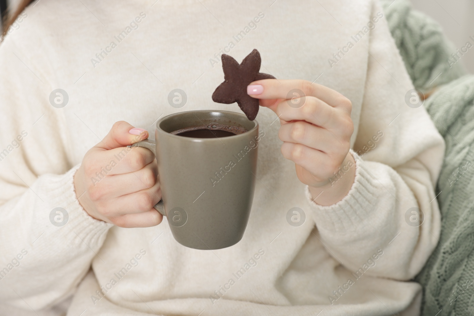 Photo of Woman having tasty hot chocolate with cookie, closeup