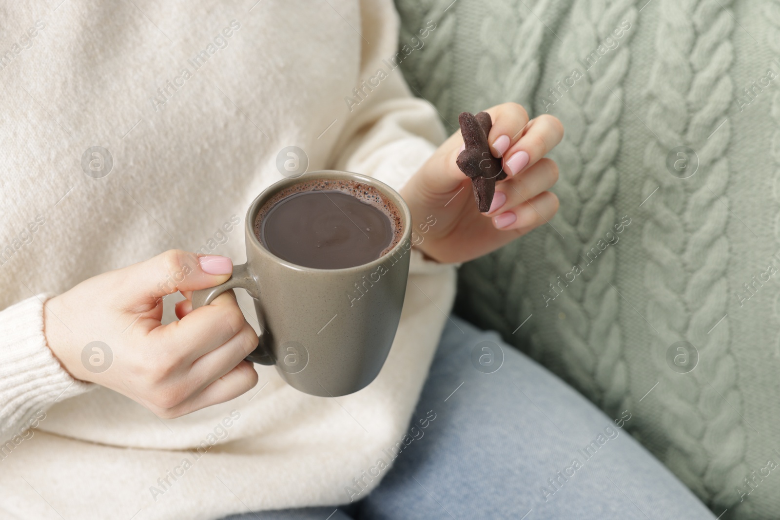 Photo of Woman having tasty hot chocolate with cookie, closeup