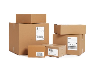 Photo of Many parcels with shipment labels isolated on white