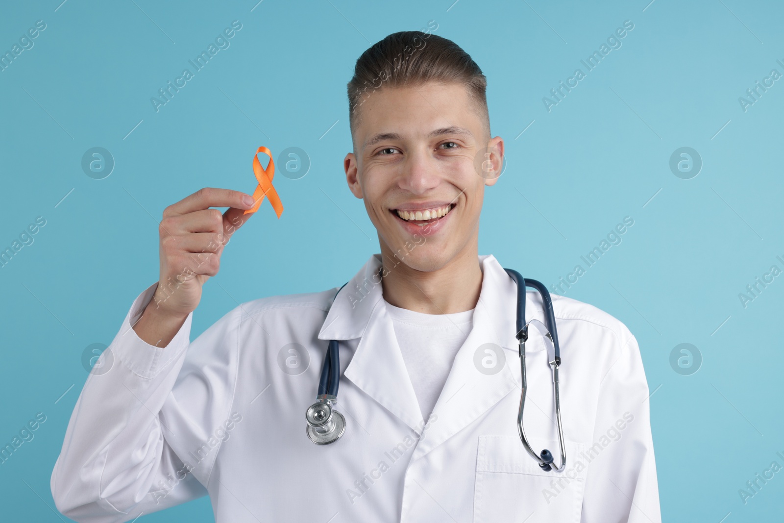 Photo of Multiple Sclerosis awareness. Doctor with orange ribbon on light blue background