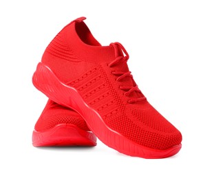 Photo of Pair of red sneakers isolated on white. Sportive shoes