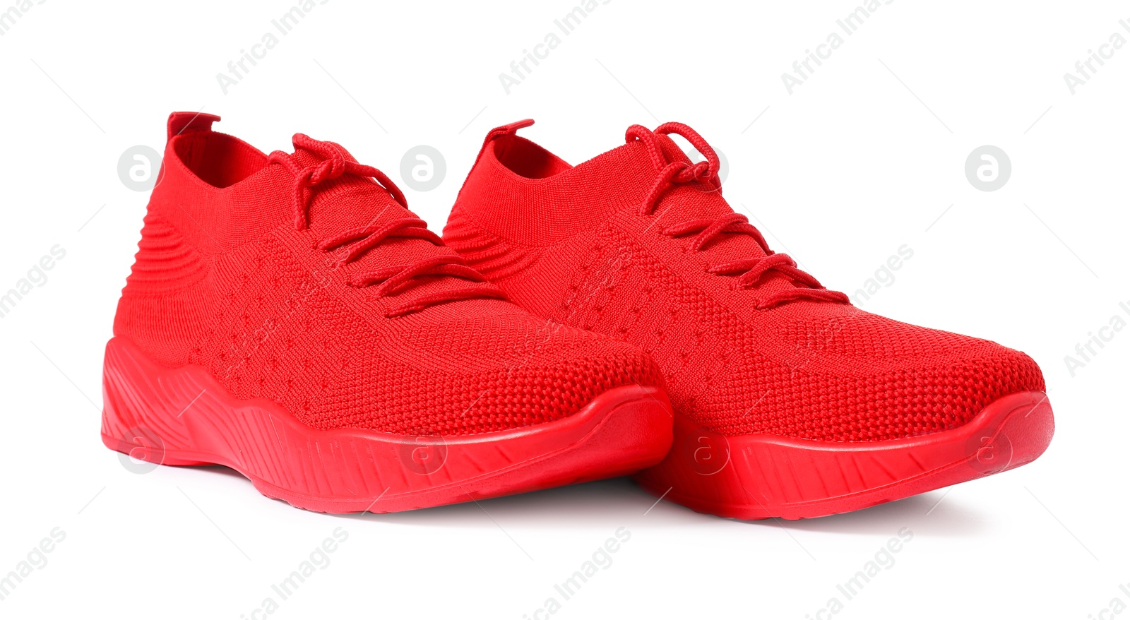 Photo of Pair of red sneakers isolated on white. Sportive shoes