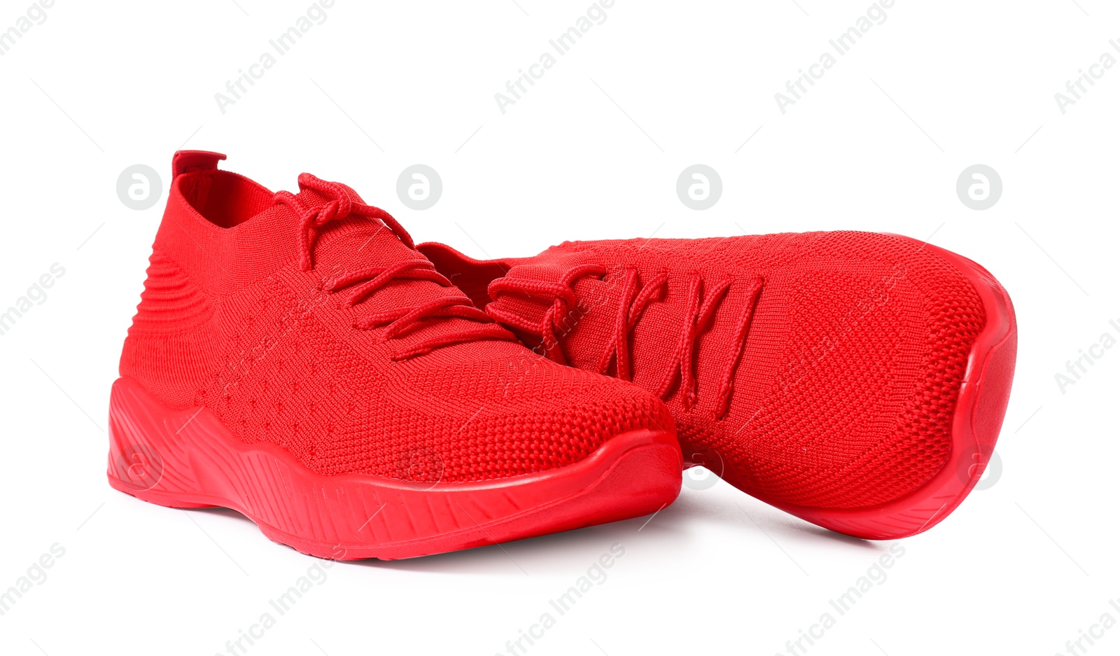 Photo of Pair of red sneakers isolated on white. Sportive shoes