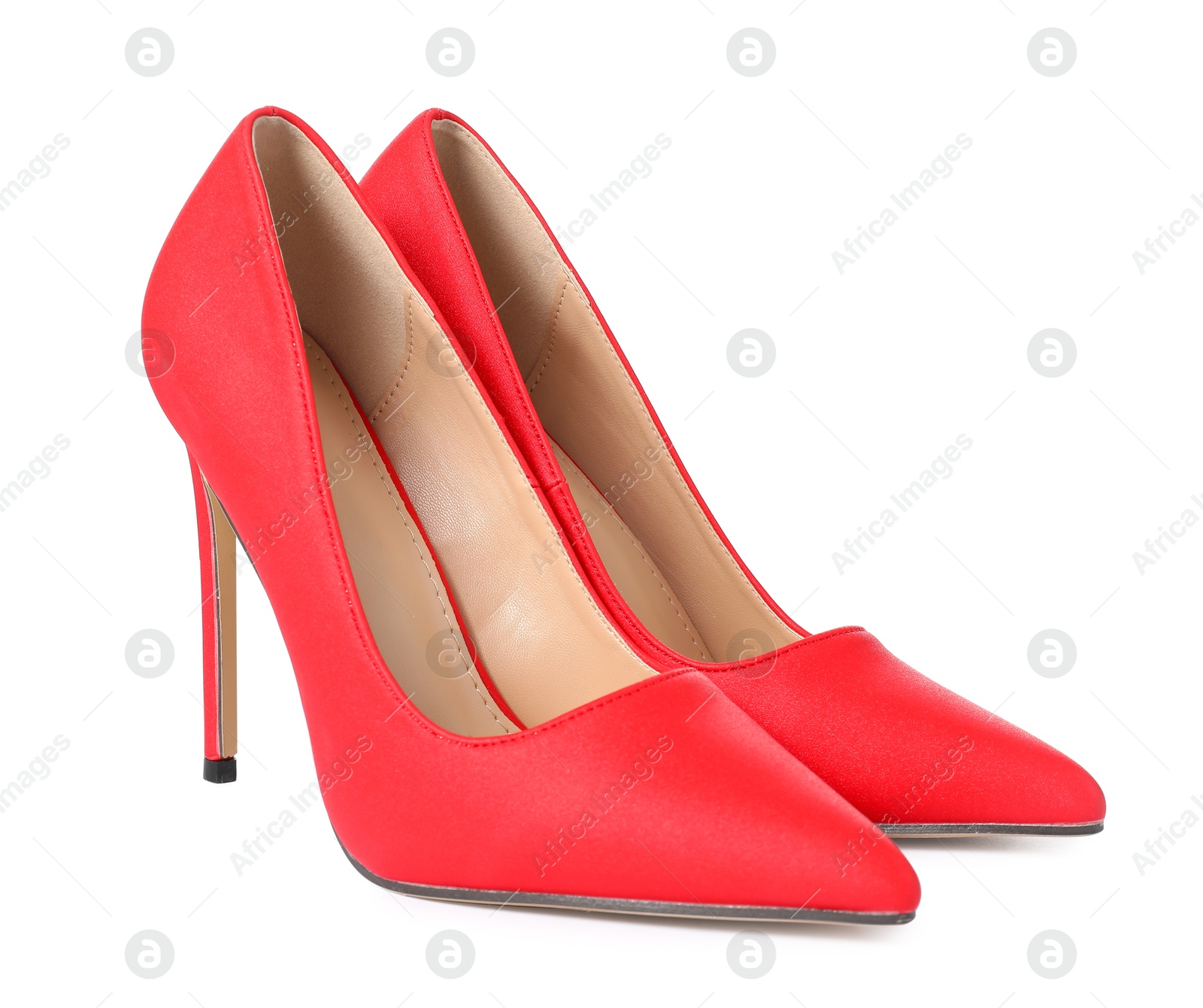 Photo of Beautiful red high heeled shoes isolated on white