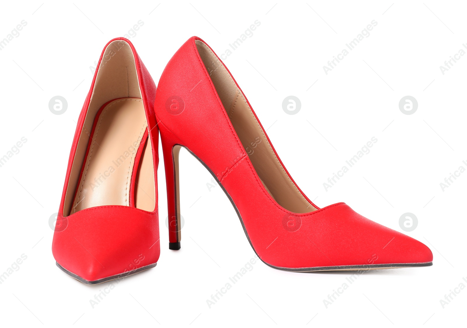 Photo of Beautiful red high heeled shoes isolated on white