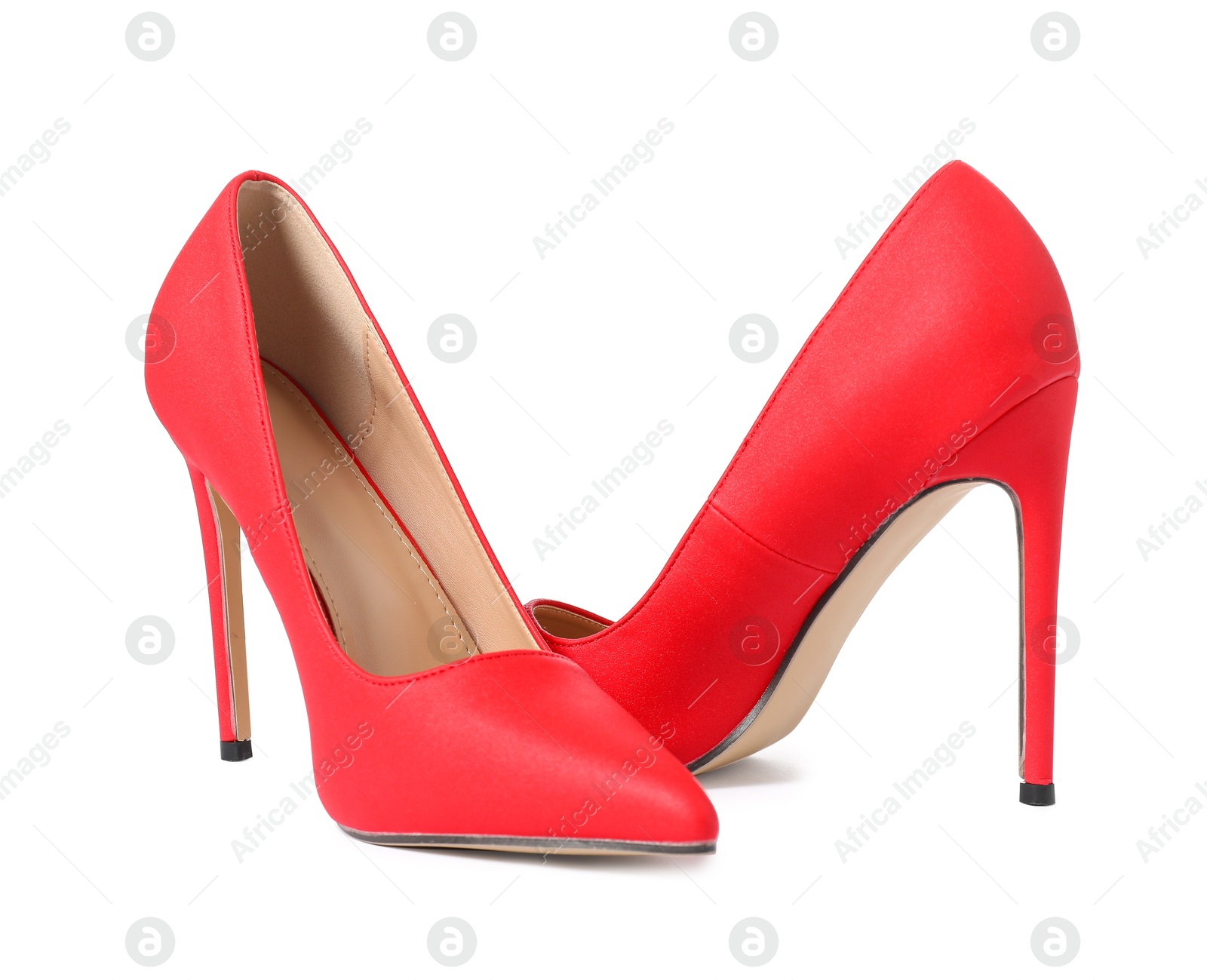 Photo of Beautiful red high heeled shoes isolated on white