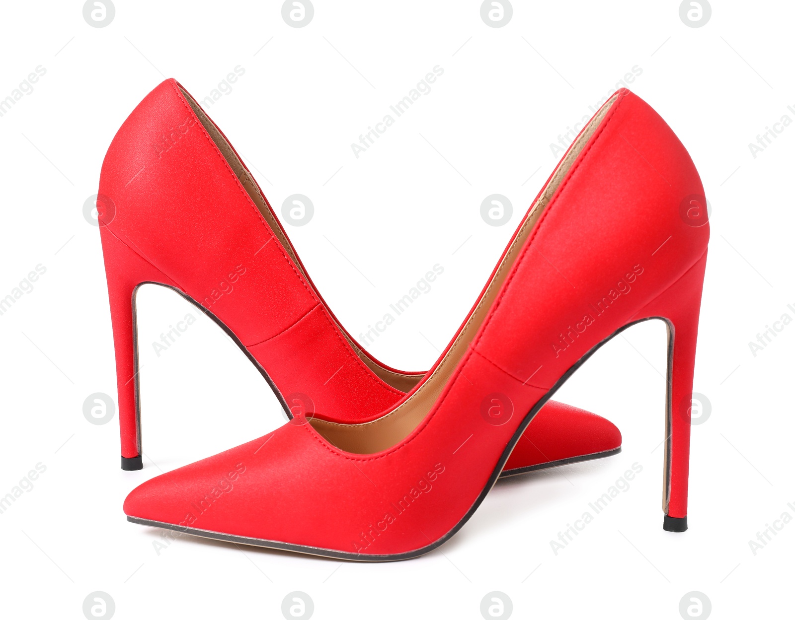 Photo of Beautiful red high heeled shoes isolated on white