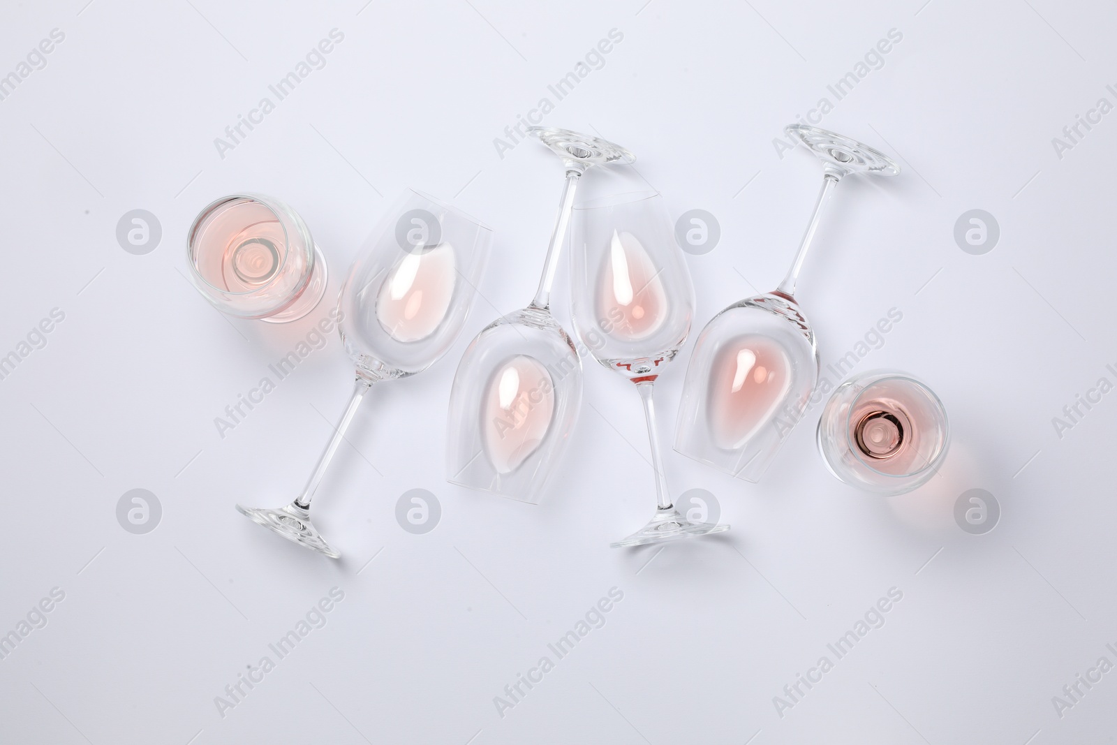 Photo of Many wineglasses on white background, flat lay