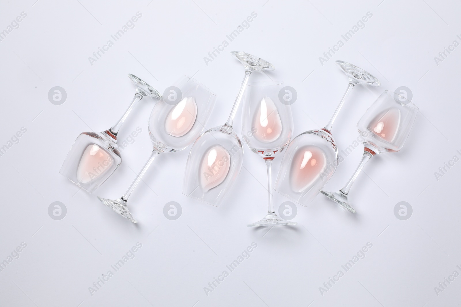 Photo of Many wineglasses on white background, flat lay