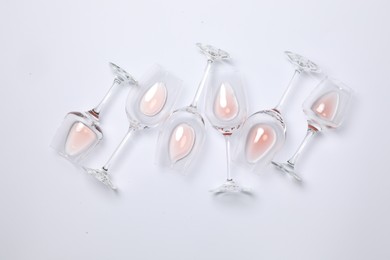 Photo of Many wineglasses on white background, flat lay