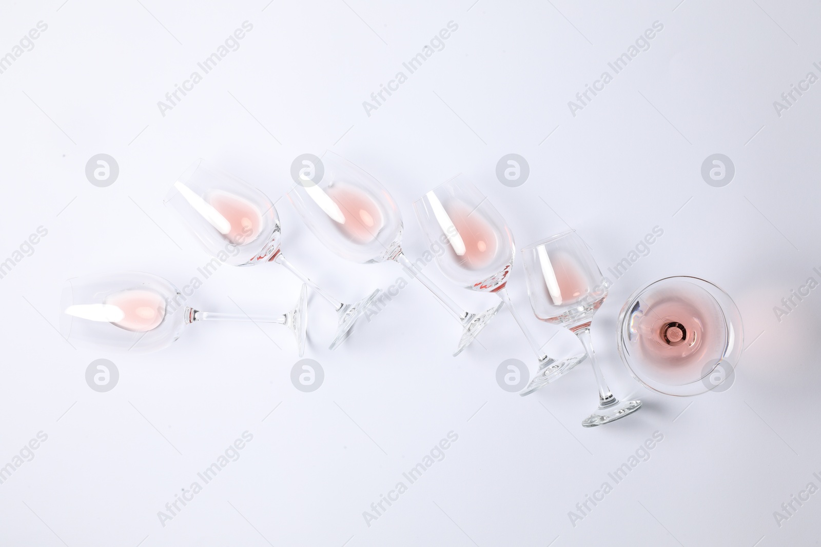 Photo of Many wineglasses on white background, flat lay