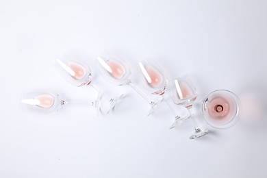 Many wineglasses on white background, flat lay