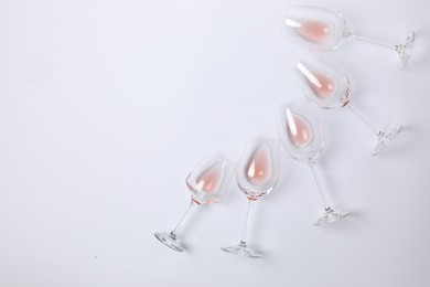 Photo of Wineglasses on white background, flat lay. Space for text