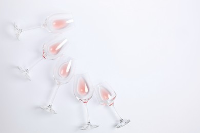 Photo of Wineglasses on white background, flat lay. Space for text