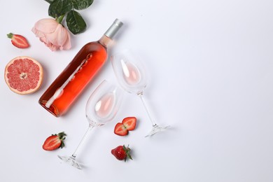 Photo of Flat lay composition with rose wine and fruits on white background. Space for text