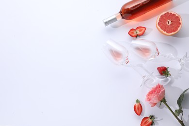 Photo of Flat lay composition with rose wine and fruits on white background. Space for text