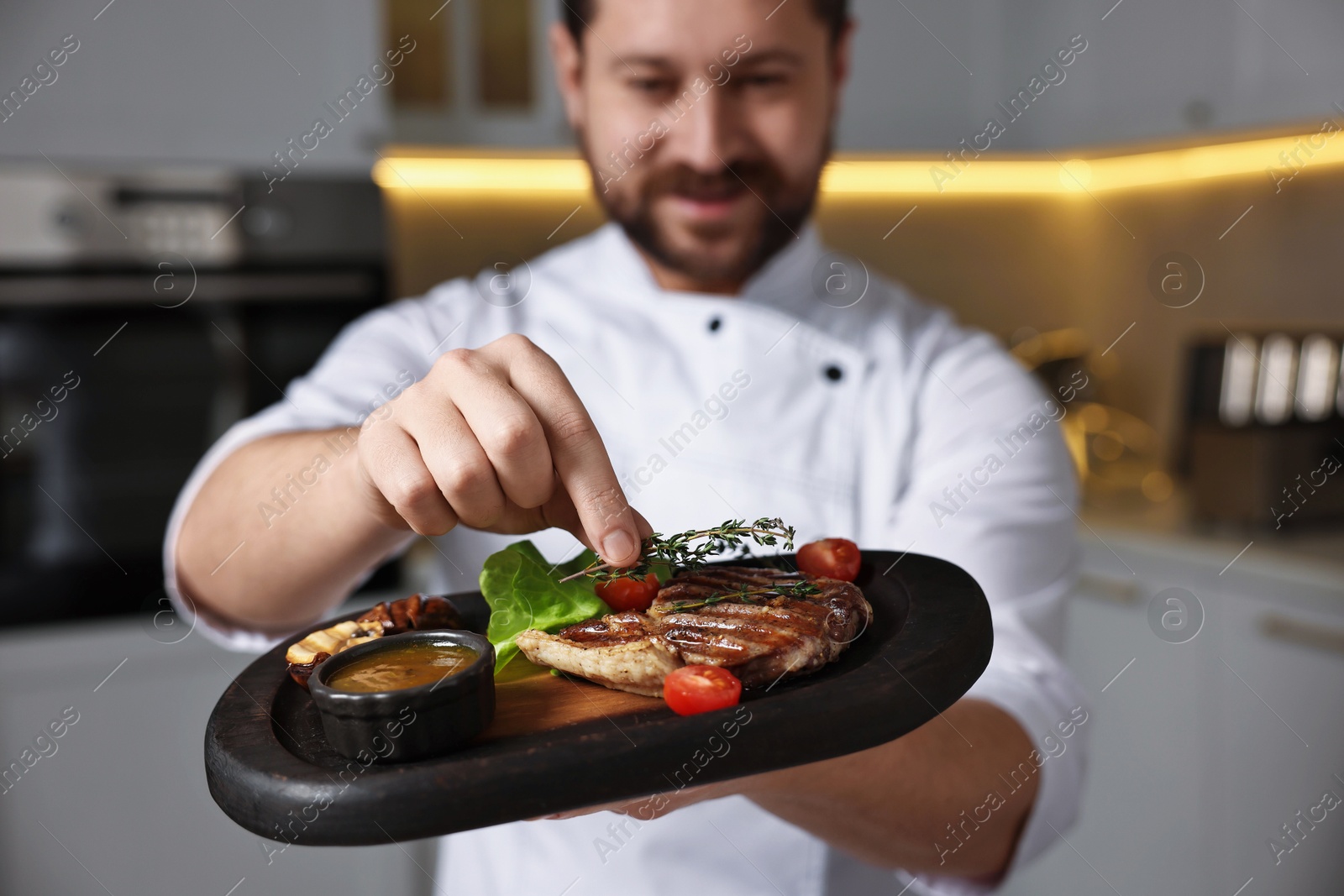 Photo of Professional chef serving delicious dish indoors, selective focus