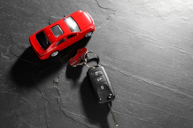 Photo of Car key and model on grey background. Buying auto