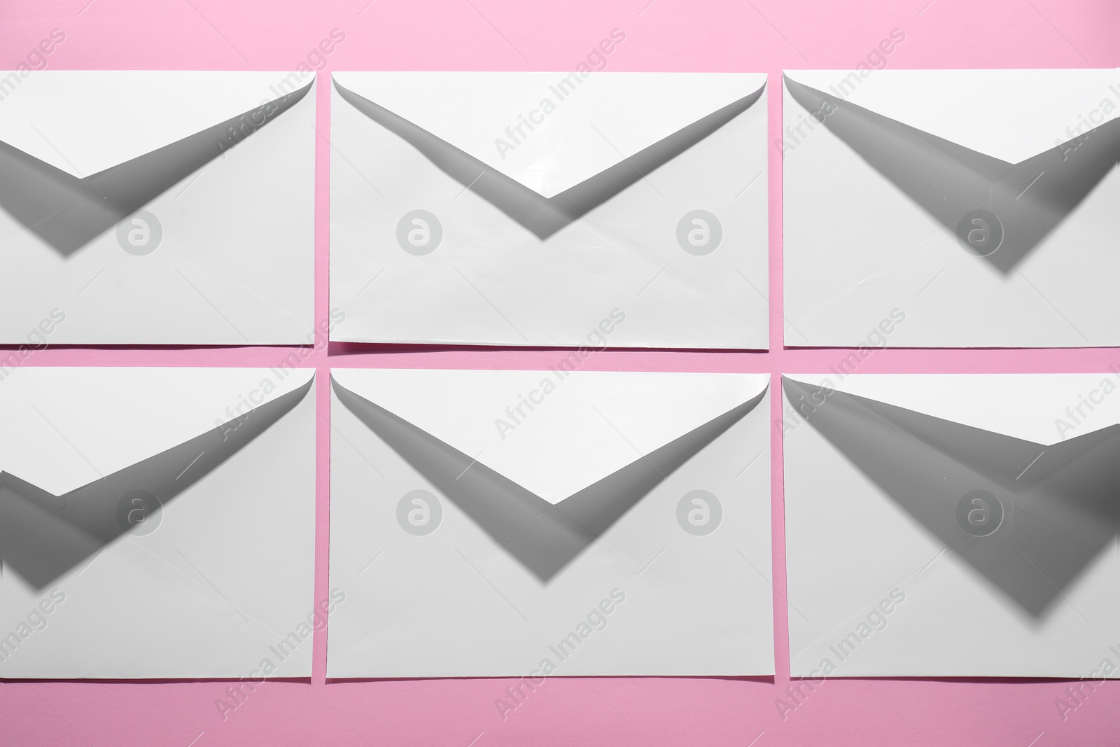 Photo of Paper envelopes on pink background, above view. Mockup for design