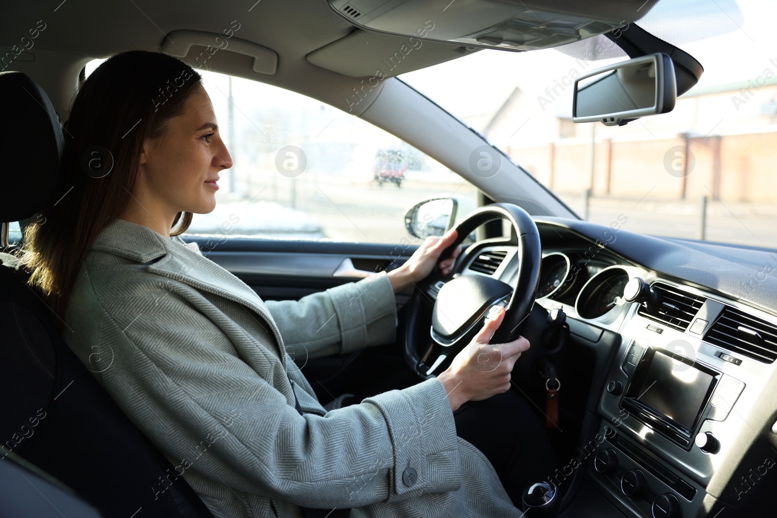 Photo of Driver behind steering wheel of modern car