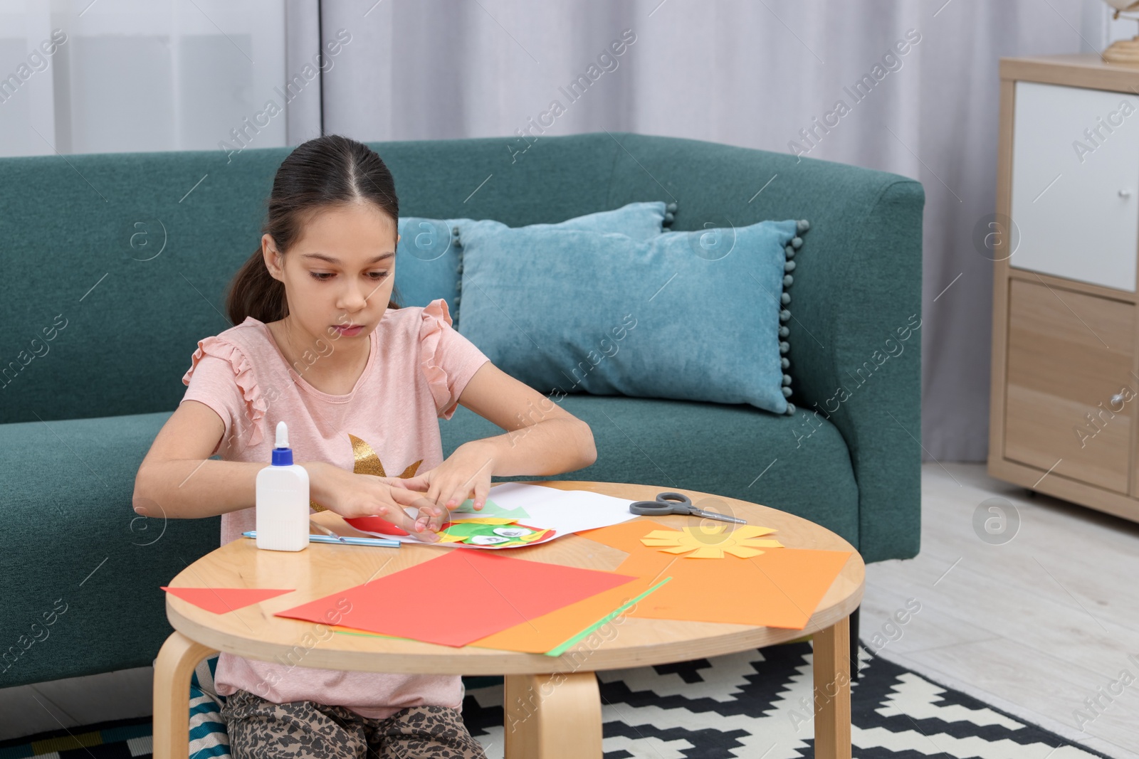 Photo of Girl making art project at table indoors