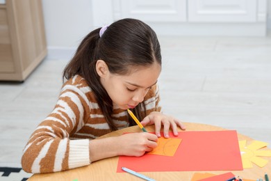 Photo of Girl drawing card at table indoors. Art and craft