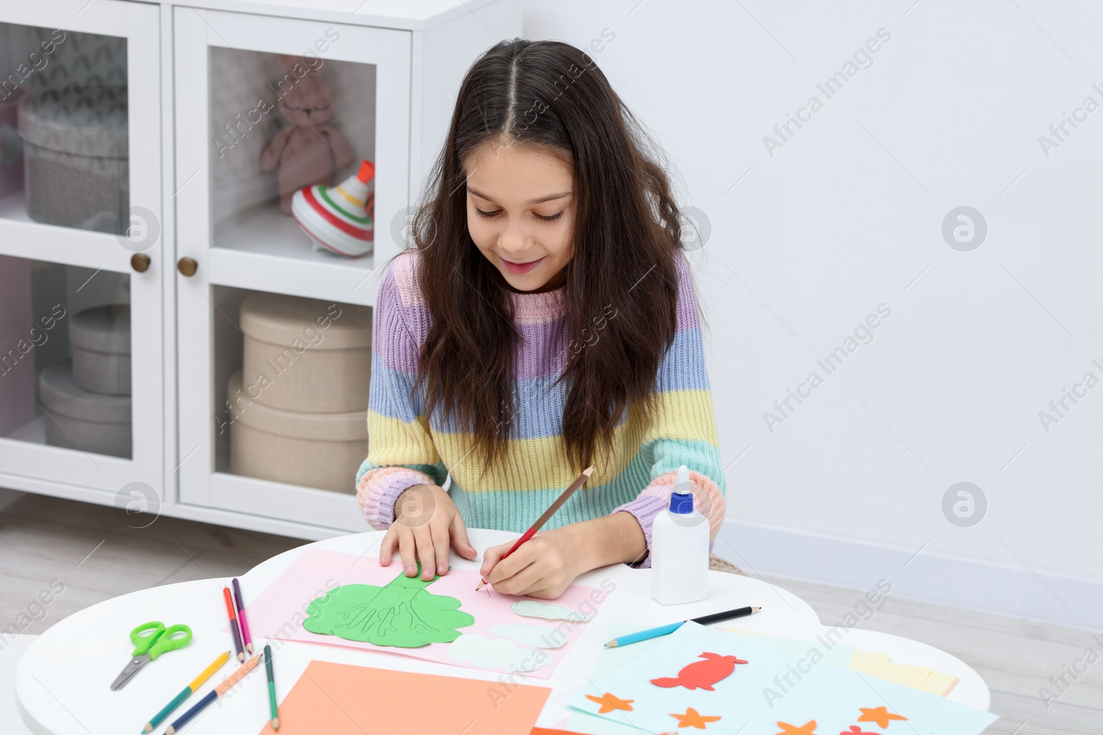 Photo of Girl drawing card at table indoors. Art and craft