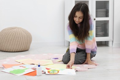 Photo of Girl making art project at home. Space for text