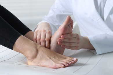 Photo of Doctor examining patient's foot in hospital, closeup