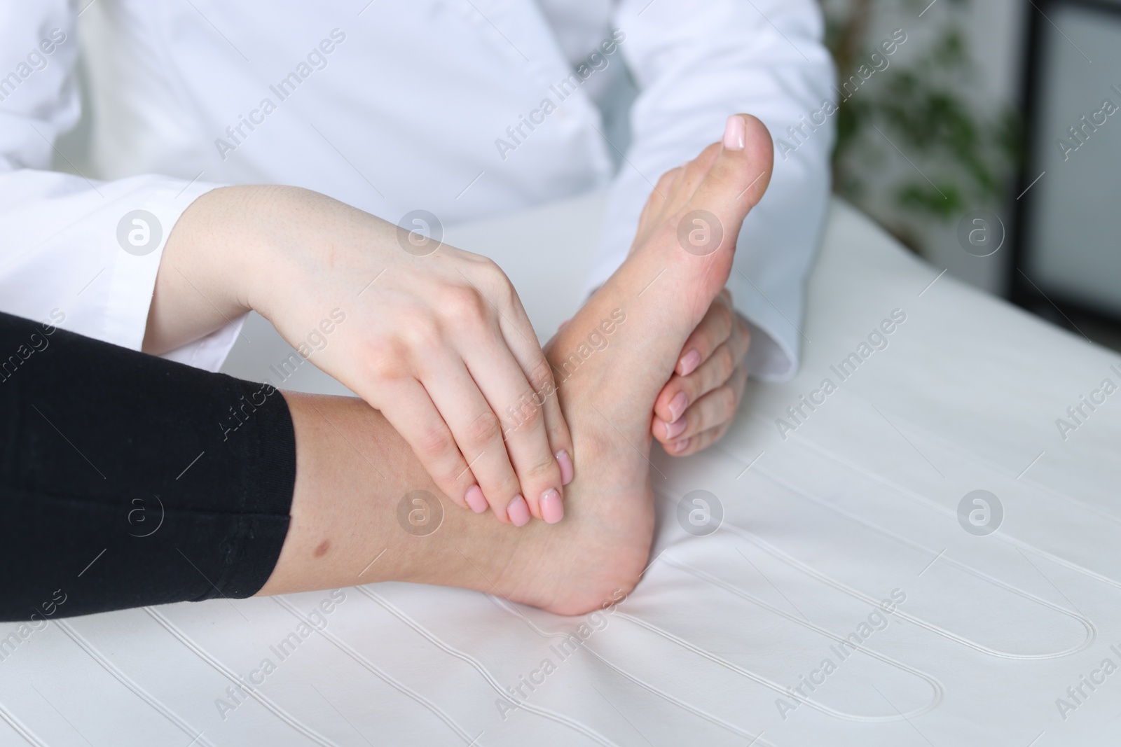 Photo of Doctor examining patient's foot in hospital, closeup