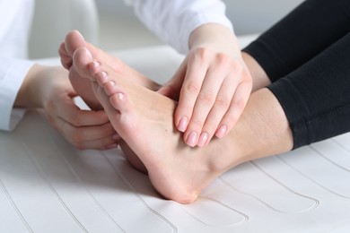 Photo of Doctor examining patient's foot in hospital, closeup