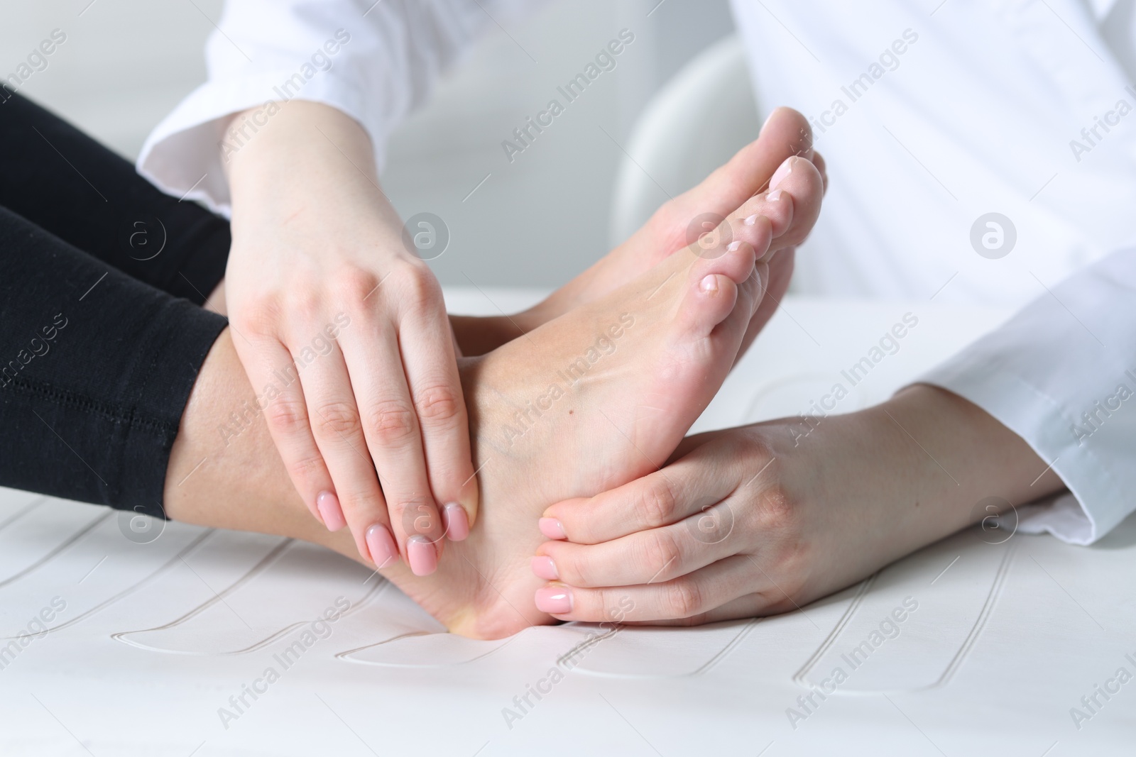 Photo of Doctor examining patient's foot in hospital, closeup