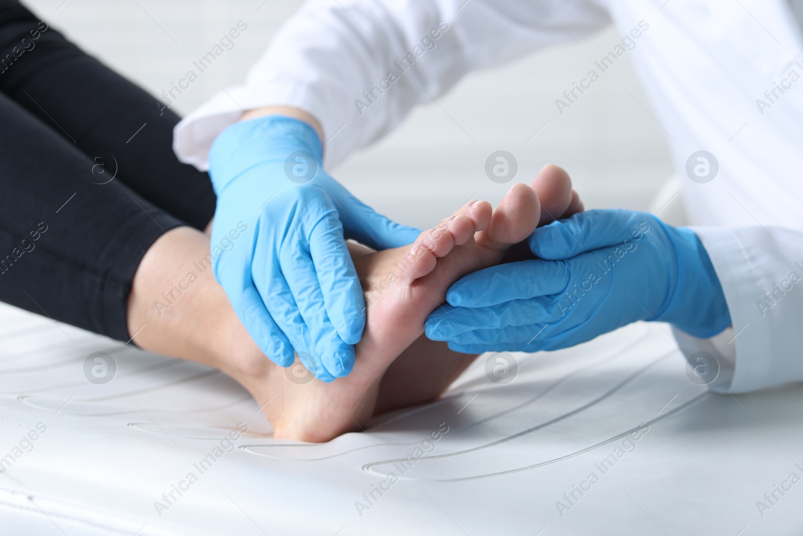 Photo of Doctor examining patient's foot in hospital, closeup