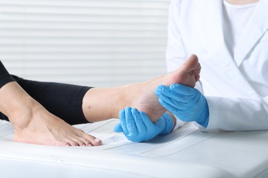 Photo of Doctor examining patient's foot in hospital, closeup