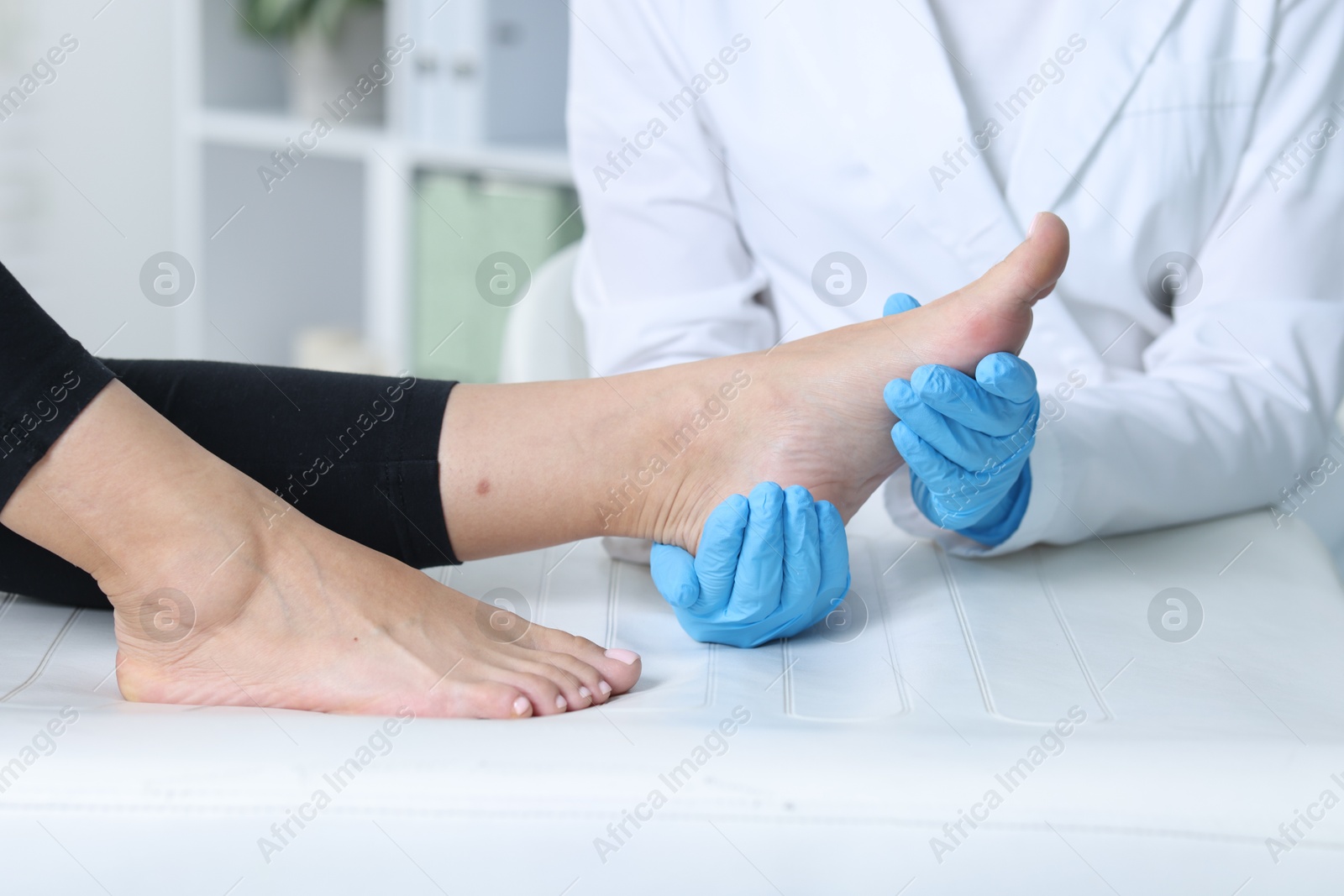 Photo of Doctor examining patient's foot in hospital, closeup