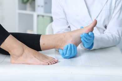 Photo of Doctor examining patient's foot in hospital, closeup