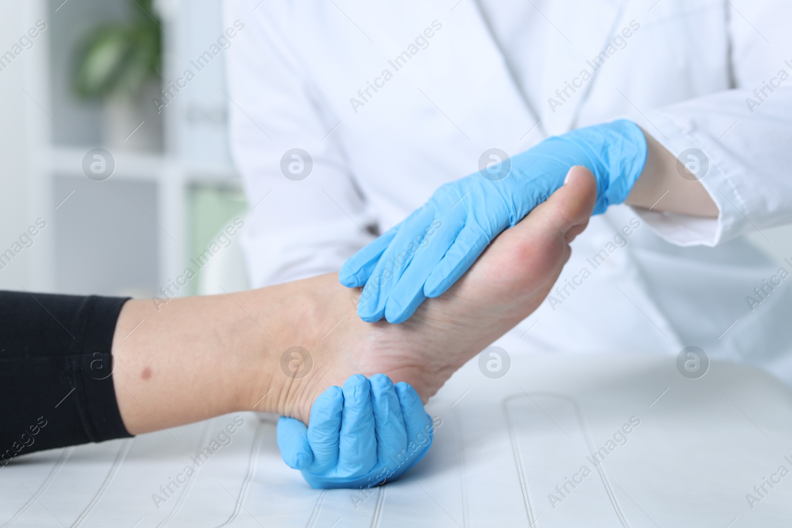 Photo of Doctor examining patient's foot in hospital, closeup