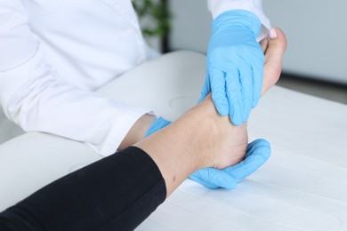 Photo of Doctor examining patient's foot in hospital, closeup