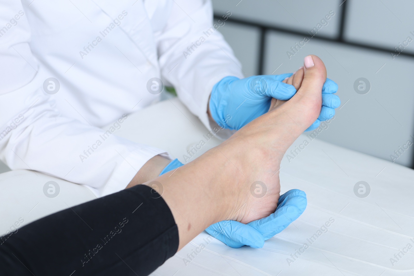 Photo of Doctor examining patient's foot in hospital, closeup