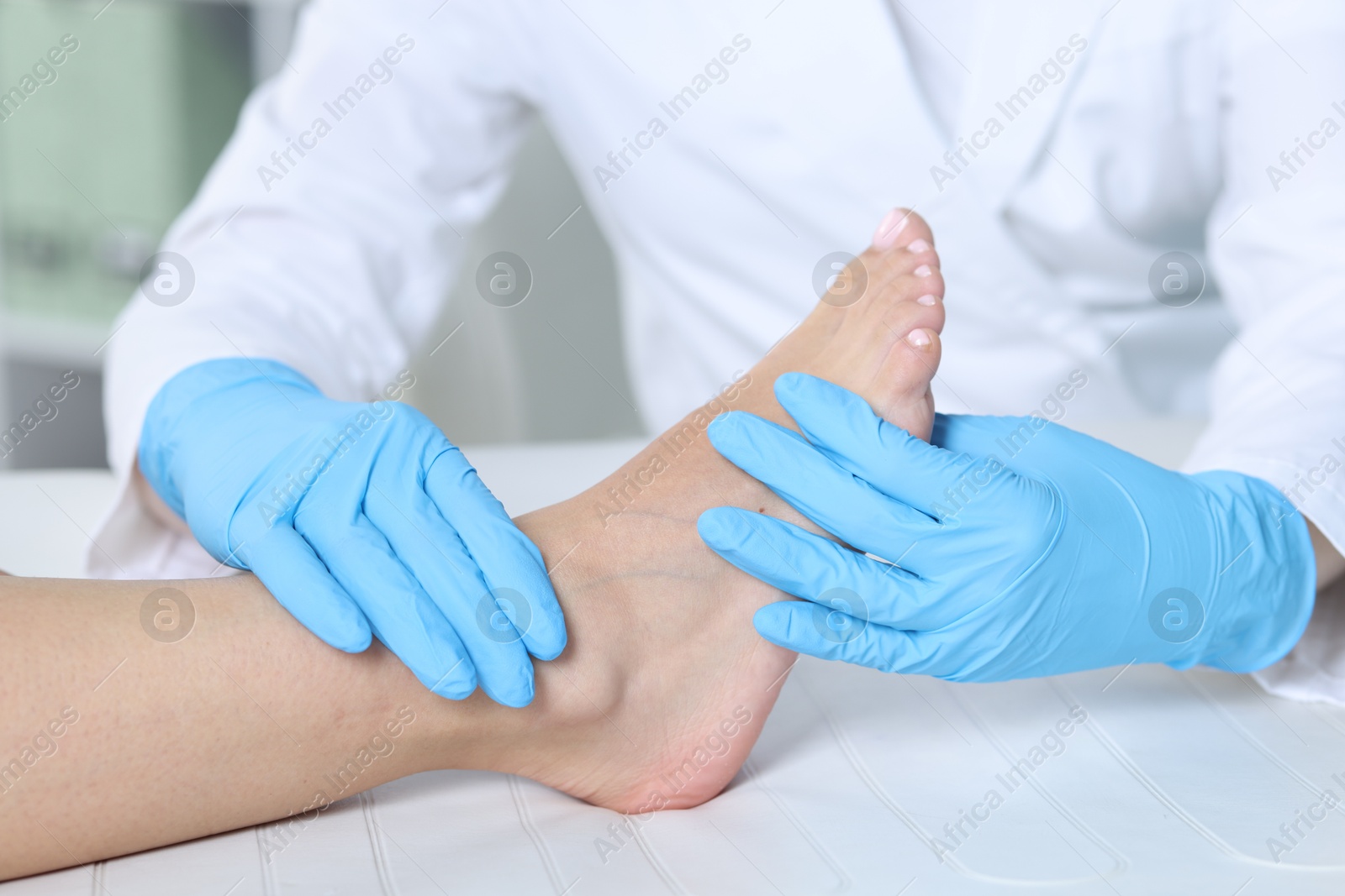 Photo of Doctor examining patient's foot in hospital, closeup