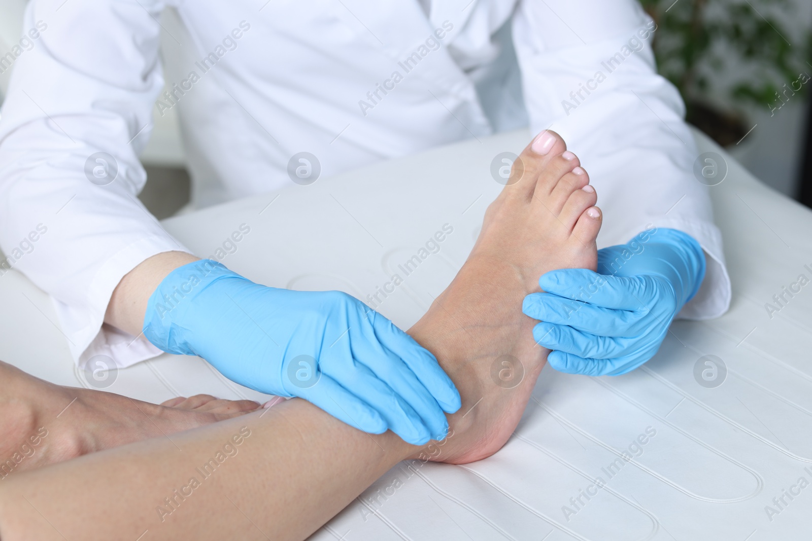 Photo of Doctor examining patient's foot in hospital, closeup