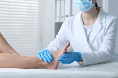 Photo of Doctor examining patient's foot in hospital, closeup