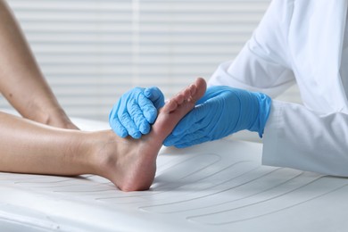 Photo of Doctor examining patient's foot in hospital, closeup