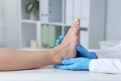 Photo of Doctor examining patient's foot in hospital, closeup