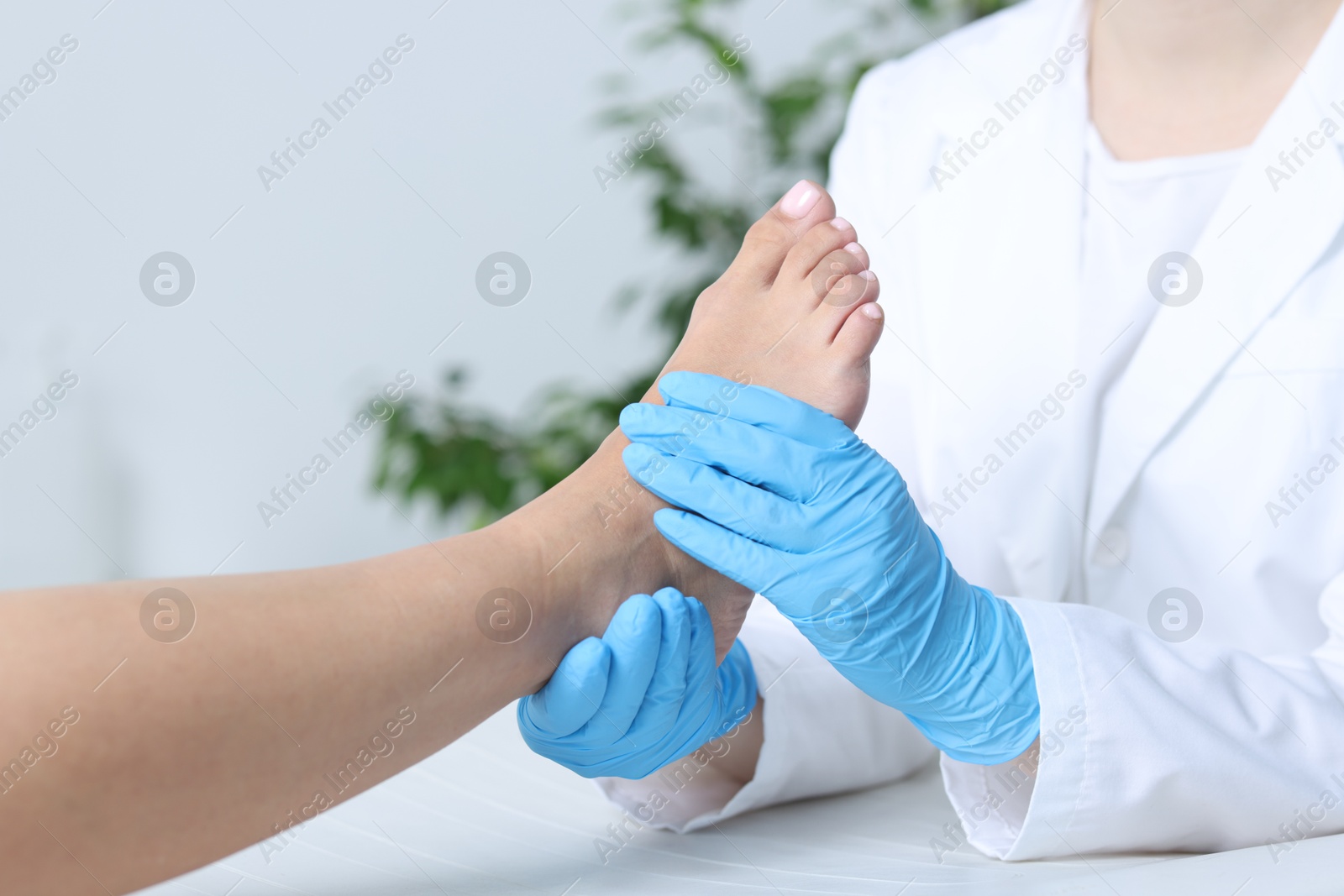 Photo of Doctor examining patient's foot in hospital, closeup