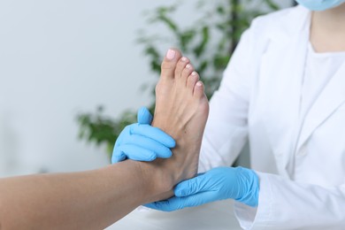 Photo of Doctor examining patient's foot in hospital, closeup