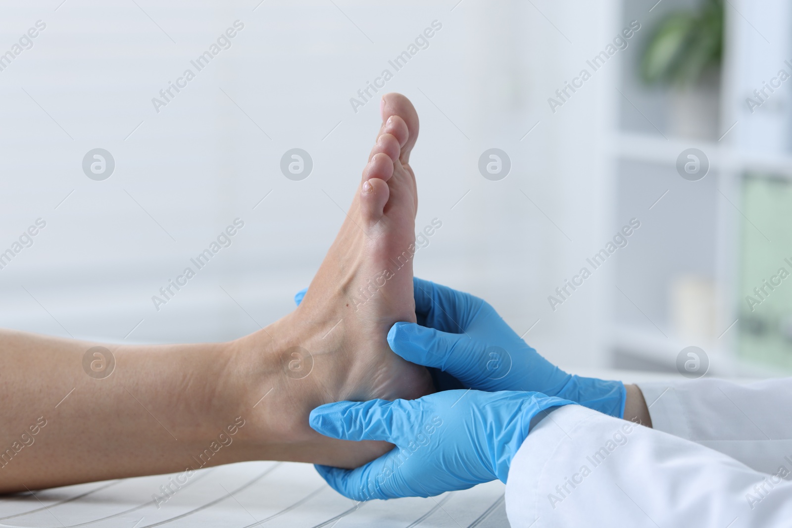 Photo of Doctor examining patient's foot in hospital, closeup