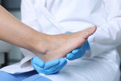 Photo of Doctor examining patient's foot in hospital, closeup