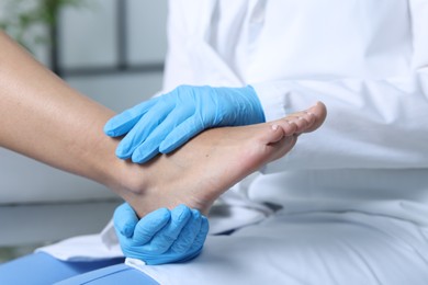 Photo of Doctor examining patient's foot in hospital, closeup