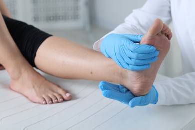 Photo of Doctor examining patient's foot in hospital, closeup